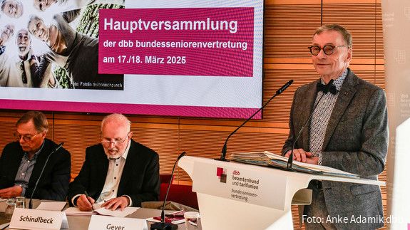 Ein Mann in Anzug steht an einem Rednerpult.