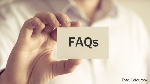 FAQ für Beamtinnen und Beamte - Einkommensrunde Closeup on businessman holding a card with text FAQs , business concept image with soft focus background and vintage tone